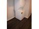 Stackable washer and dryer in laundry area with dark wood floors at 5315 Austrian Pine Ct, Cumming, GA 30040