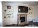 Living room boasts stone fireplace flanked by built-in shelving and large screen television at 5315 Austrian Pine Ct, Cumming, GA 30040