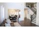 Elegant living room featuring hardwood floors, staircase, and view into dining area at 5315 Austrian Pine Ct, Cumming, GA 30040