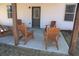 Outdoor patio featuring multiple wooden chairs with a white house in the background at 5315 Austrian Pine Ct, Cumming, GA 30040