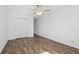 Bedroom with wood-look flooring, ceiling fan and closet with bi-fold doors at 2388 Lawrenceville Hwy # M, Decatur, GA 30033