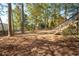 Backyard with mature trees, walkway, and access to the deck, providing a relaxing outdoor space at 4711 Oakleigh Manor Dr, Powder Springs, GA 30127
