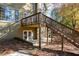 Backyard staircase with access to the elevated deck and lower-level patio, perfect for outdoor relaxation at 4711 Oakleigh Manor Dr, Powder Springs, GA 30127