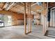 Unfinished basement with concrete floors, exposed wood framing, and a walkout door for customization at 4711 Oakleigh Manor Dr, Powder Springs, GA 30127