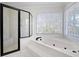 Bathroom featuring separate shower and tub, tile flooring, and natural light at 4711 Oakleigh Manor Dr, Powder Springs, GA 30127