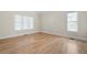 Serene bedroom with hardwood floors and natural light from two windows at 4711 Oakleigh Manor Dr, Powder Springs, GA 30127