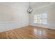 Elegant dining room with hardwood floors, decorative molding, and stylish light fixture at 4711 Oakleigh Manor Dr, Powder Springs, GA 30127