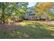 Charming two-story home with mature trees and a well-maintained front yard at 4711 Oakleigh Manor Dr, Powder Springs, GA 30127
