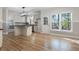 Eat-in kitchen has hardwood floors, white cabinets, stainless appliances, and a view of the backyard at 4711 Oakleigh Manor Dr, Powder Springs, GA 30127