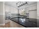 Bright kitchen features stainless appliances, a modern light fixture, and a granite island cooktop at 4711 Oakleigh Manor Dr, Powder Springs, GA 30127