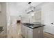 Open concept kitchen flows into the living room with hardwood floors and a brick fireplace at 4711 Oakleigh Manor Dr, Powder Springs, GA 30127