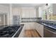 Updated kitchen featuring stainless appliances, granite countertops, and a modern backsplash at 4711 Oakleigh Manor Dr, Powder Springs, GA 30127