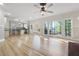 An open-concept living area features hardwood floors and connects to a kitchen with stainless appliances at 4711 Oakleigh Manor Dr, Powder Springs, GA 30127