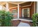 Inviting front porch with brick facade and decorative columns at 4711 Oakleigh Manor Dr, Powder Springs, GA 30127
