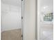 Walk-in closet with carpeted floor and view of sitting room with windows at 4711 Oakleigh Manor Dr, Powder Springs, GA 30127