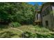 Side of house with large backyard and bordering trees at 5730 Paces Pl, Suwanee, GA 30024