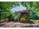 Exterior backyard view with wooden fence, deck, and mature trees at 5730 Paces Pl, Suwanee, GA 30024