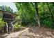 Wooded backyard with deck, stairs and mature trees at 5730 Paces Pl, Suwanee, GA 30024