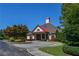 Charming clubhouse featuring a red roof, stone accents, and manicured landscaping provides a welcoming community gathering space at 5730 Paces Pl, Suwanee, GA 30024