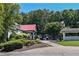 Charming clubhouse exterior with golf carts, landscaping, and covered entrance at 5730 Paces Pl, Suwanee, GA 30024