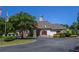 Charming clubhouse exterior showcasing red shutters, lush landscaping, and golf cart parking at 5730 Paces Pl, Suwanee, GA 30024