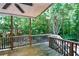 Relaxing backyard deck surrounded by mature trees, perfect for entertaining at 5730 Paces Pl, Suwanee, GA 30024