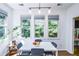 Sunlit dining area with a white table, gray chairs, and a plant in the corner at 5730 Paces Pl, Suwanee, GA 30024