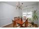 Bright dining room with modern light fixture, wood floors, and lots of natural light at 5730 Paces Pl, Suwanee, GA 30024