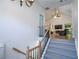 Bright entryway features vaulted ceiling, stairs with wood and iron railing, and view of the living room at 5730 Paces Pl, Suwanee, GA 30024