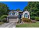 Charming two-story home with a well-maintained lawn, lush landscaping, and an attached two-car garage at 5730 Paces Pl, Suwanee, GA 30024