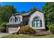 Charming two-story home with a well-maintained lawn, lush landscaping, and an attached two-car garage at 5730 Paces Pl, Suwanee, GA 30024