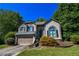 Charming two-story home with a well-maintained lawn, lush landscaping, and an attached two-car garage at 5730 Paces Pl, Suwanee, GA 30024