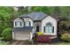 Charming two-story home with a well-maintained lawn, lush landscaping, and an attached two-car garage at 5730 Paces Pl, Suwanee, GA 30024