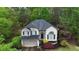 Charming two-story home with a well-maintained lawn, lush landscaping, and an attached two-car garage at 5730 Paces Pl, Suwanee, GA 30024