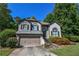 Charming two-story home with a well-maintained lawn, lush landscaping, and an attached two-car garage at 5730 Paces Pl, Suwanee, GA 30024