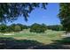 Picturesque golf course view featuring lush greenery, mature trees, and blue sky at 5730 Paces Pl, Suwanee, GA 30024