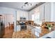 Updated kitchen featuring stainless steel appliances, granite countertops, and white cabinets at 5730 Paces Pl, Suwanee, GA 30024