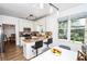 Open kitchen with stainless appliances, granite countertops and a view to dining and breakfast area at 5730 Paces Pl, Suwanee, GA 30024
