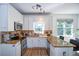 Well-lit kitchen with stainless steel appliances, granite countertops, and white cabinets at 5730 Paces Pl, Suwanee, GA 30024