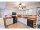 Well-equipped kitchen with white cabinets, modern appliances, and tile backsplash at 5730 Paces Pl, Suwanee, GA 30024