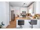 Kitchen featuring stainless steel appliances, granite countertops, white cabinets and breakfast bar seating at 5730 Paces Pl, Suwanee, GA 30024
