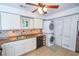 Kitchen featuring white cabinetry, modern appliances, and convenient laundry area at 5730 Paces Pl, Suwanee, GA 30024
