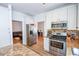 Well-equipped kitchen with stainless steel appliances and granite countertops at 5730 Paces Pl, Suwanee, GA 30024