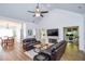 Bright living room with vaulted ceilings, fireplace, wood floors, and view of the dining room and den at 5730 Paces Pl, Suwanee, GA 30024