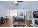 Bright living room with vaulted ceilings, fireplace, wood floors, and view of the dining room and entryway at 5730 Paces Pl, Suwanee, GA 30024