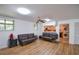 Large open living room with hard floors and a peek into the kitchen at 5730 Paces Pl, Suwanee, GA 30024