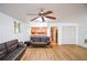 Spacious living room with hardwood floors, ceiling fan, and view of the kitchen at 5730 Paces Pl, Suwanee, GA 30024