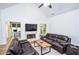 Bright living room with vaulted ceilings, fireplace, wood floors, and access to den and backyard at 5730 Paces Pl, Suwanee, GA 30024
