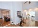 Open-concept living room with hardwood floors, neutral walls, and seamless flow into the kitchen, creating an inviting space at 5730 Paces Pl, Suwanee, GA 30024