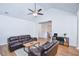 Bright living room with vaulted ceilings, wood floors, and a ceiling fan at 5730 Paces Pl, Suwanee, GA 30024